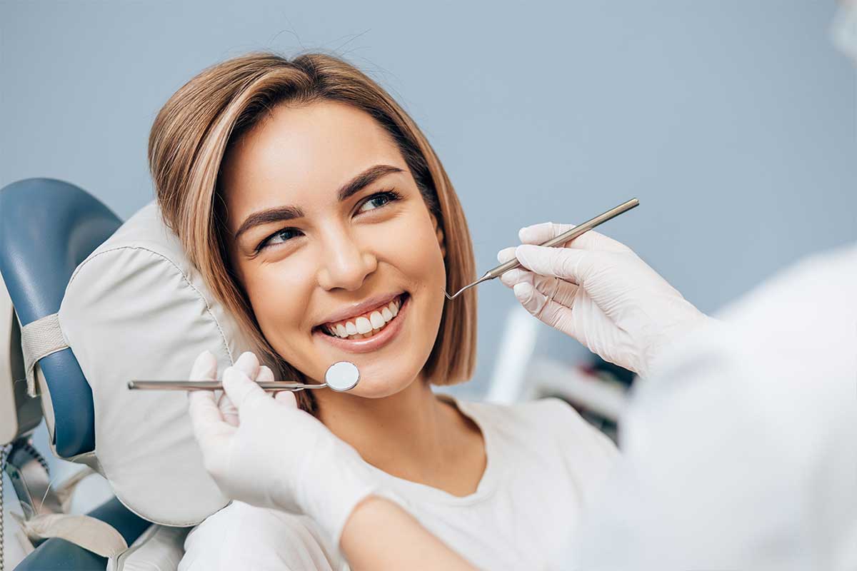 A woman smiling during routine dental checkup